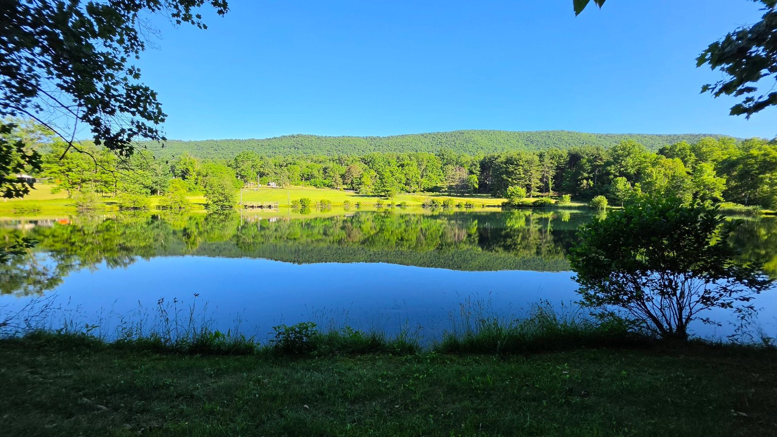 Lake and wooded hills at Back Roads Camping & RV Resort in Landisburg, Pennsylvania